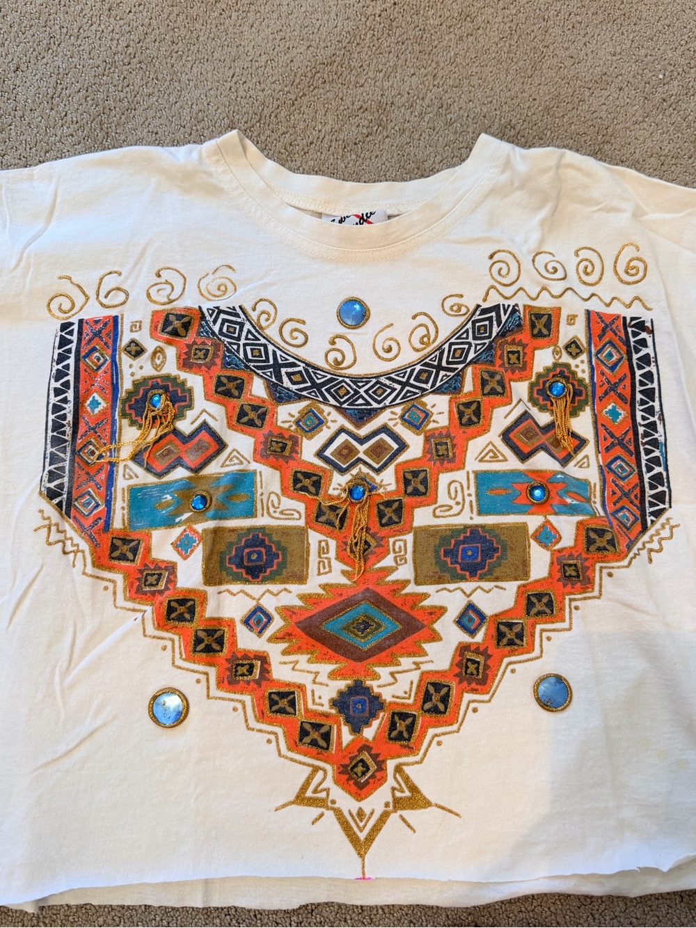 Vintage Cream Graphic T-Shirt with Tribal Print, Embellishments, and Fringe